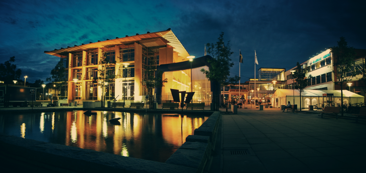 Building by the water with lights in the night.